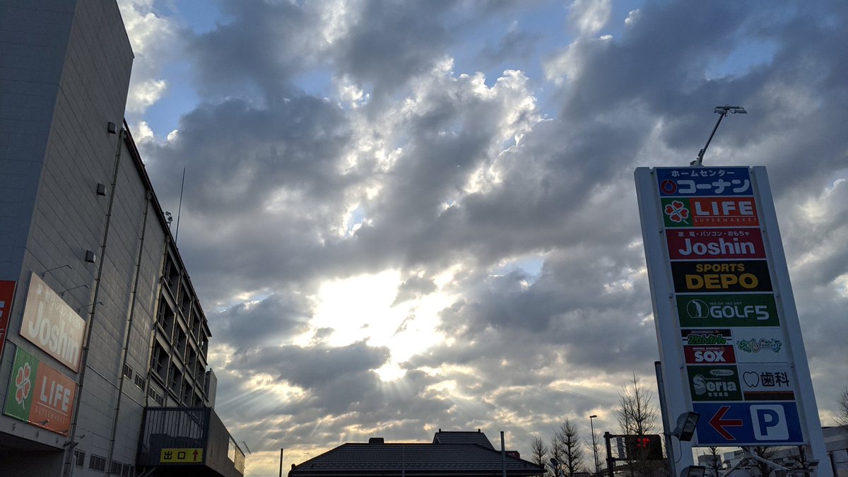 太陽から放射状に光が降る空。