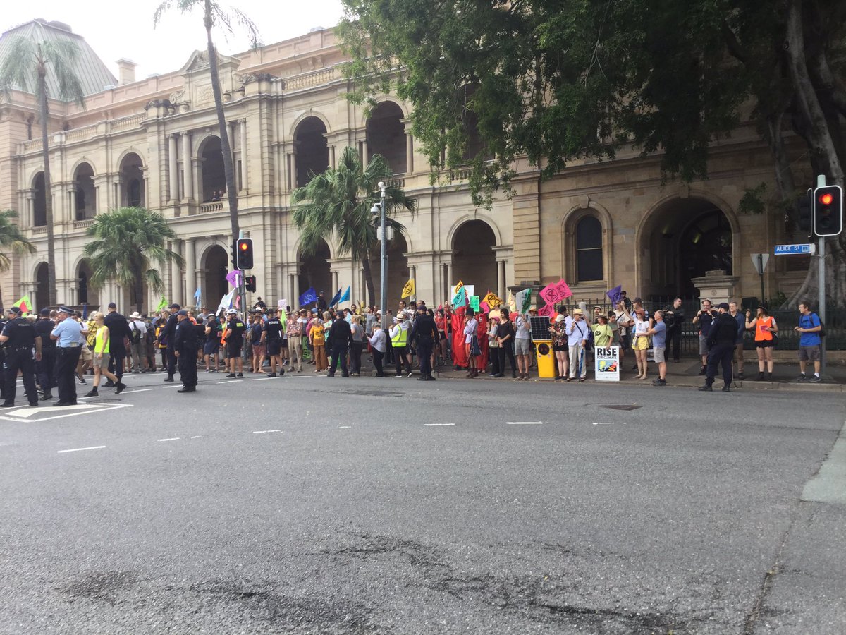Police clearing protestors from an intersection.