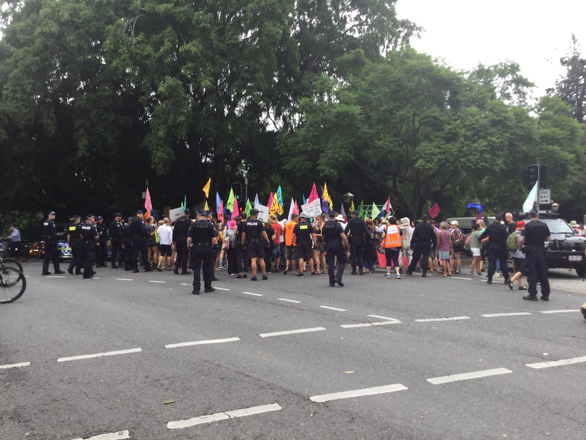 Police clearing protestors from an intersection.