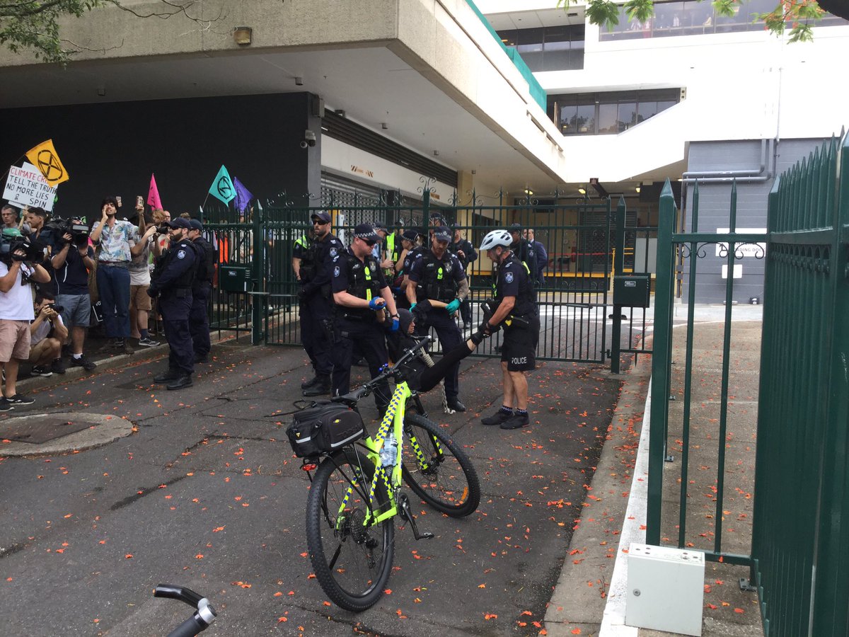 A rebel being dragged by police.