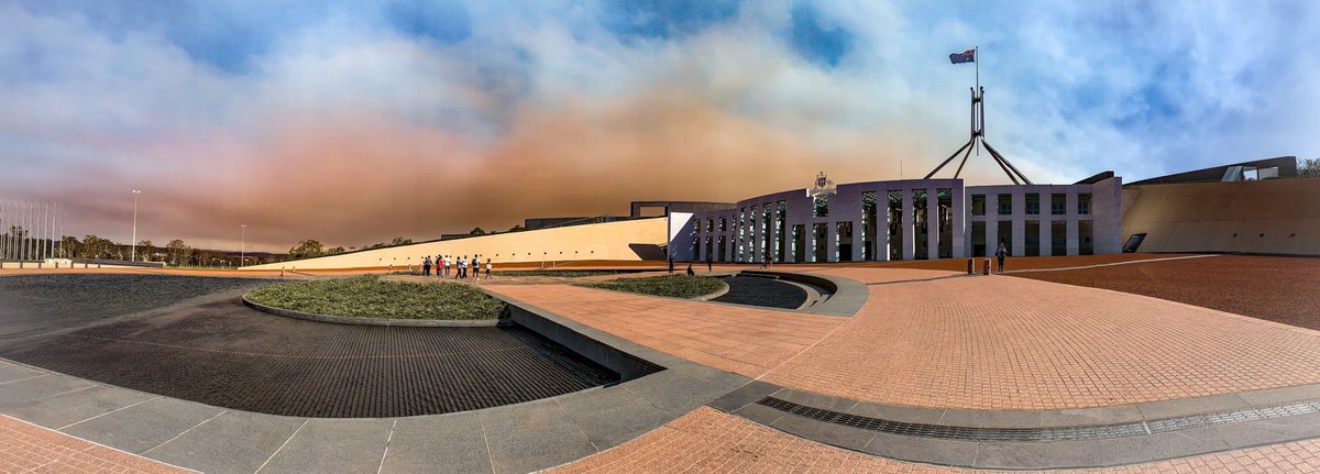 Parliament House with smoke in the sky