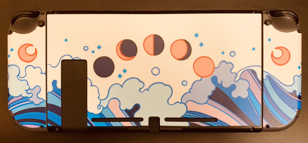 the back of a nintendo switch with the controllers attatched. you can see more waves and moons with phases.