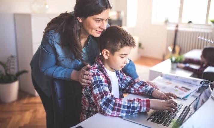 A mother homeschooling her son