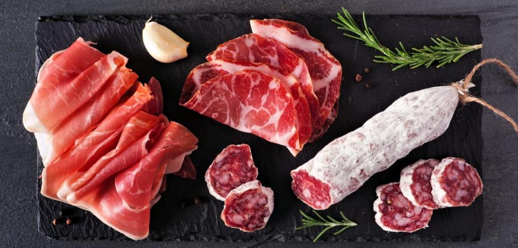 Processed red meats such as salami and sausage on a board