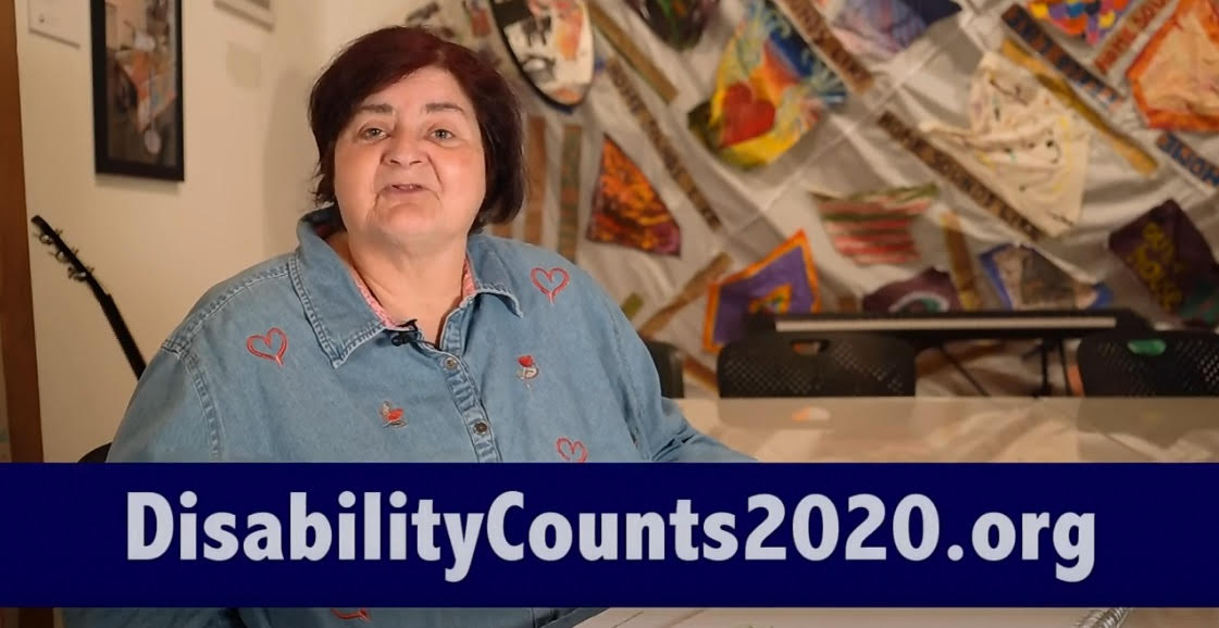 A woman with short dark hair wearing a blue shirt with small red hearts faces the camera. Words beneath her read DisabilityCounts2020.org