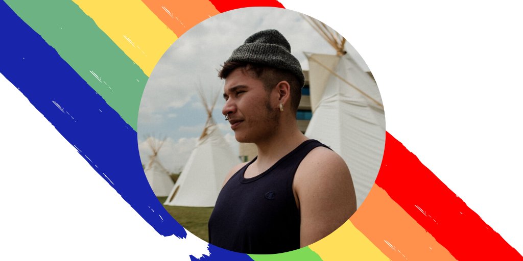 Billy-Ray looking out into the distance with the rainbow flag behind him. 