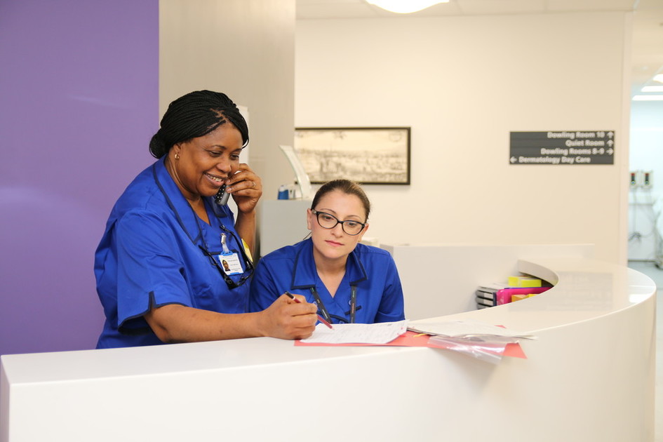 A nurse on the phone next to another nurse at a Guy's and St Thomas' community site. 