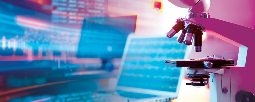 Microscope with laptops in background