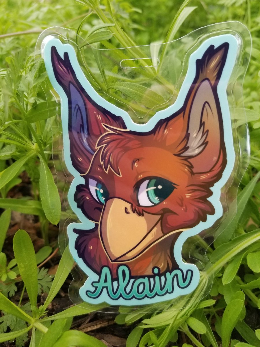 Digital file next to the printed &amp; laminated badge. Look at this cute lil' finch gryff!!

[ TFF badge commissions open ]
#furryart #furry #tff2020 #furryfiesta #furryfiesta2020 #badgeart