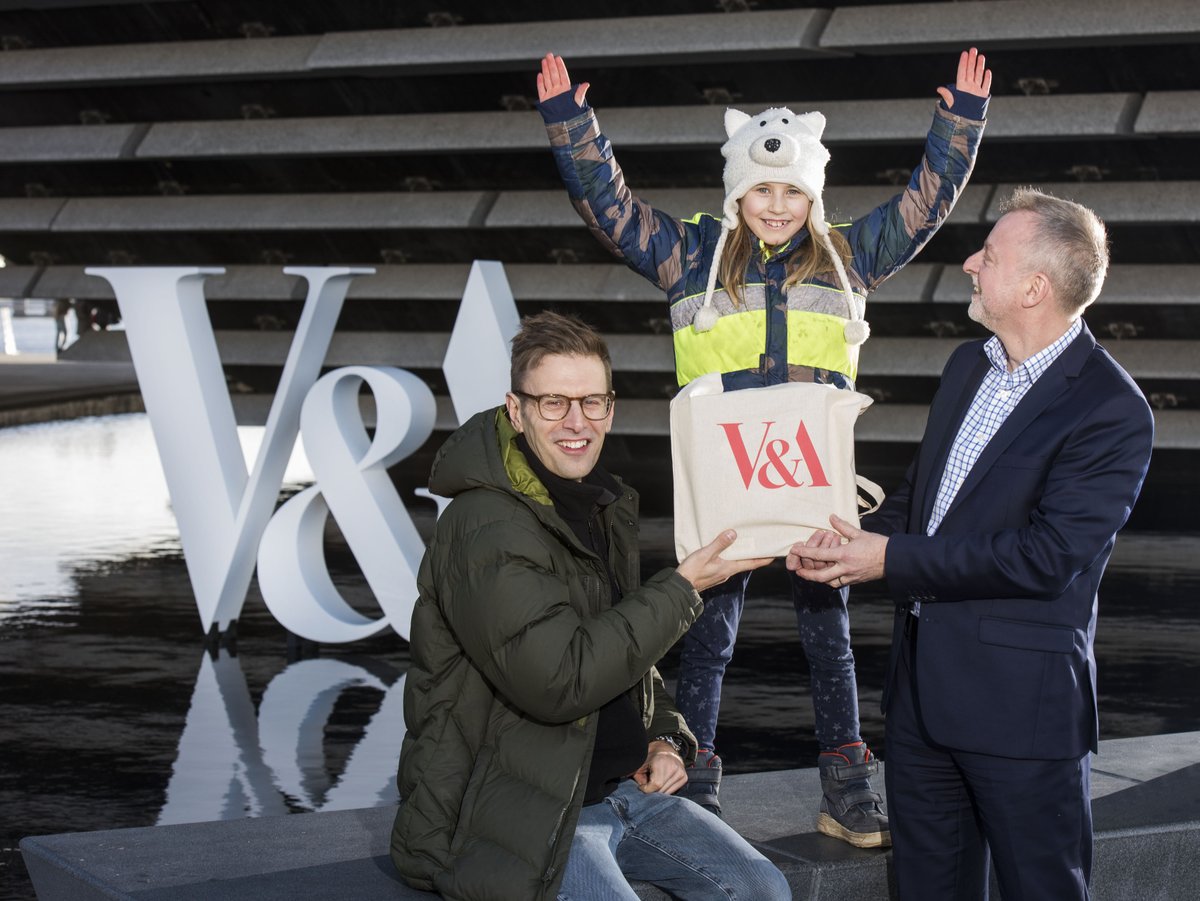 Twi adults and one child outside V&A Dundee cheering!