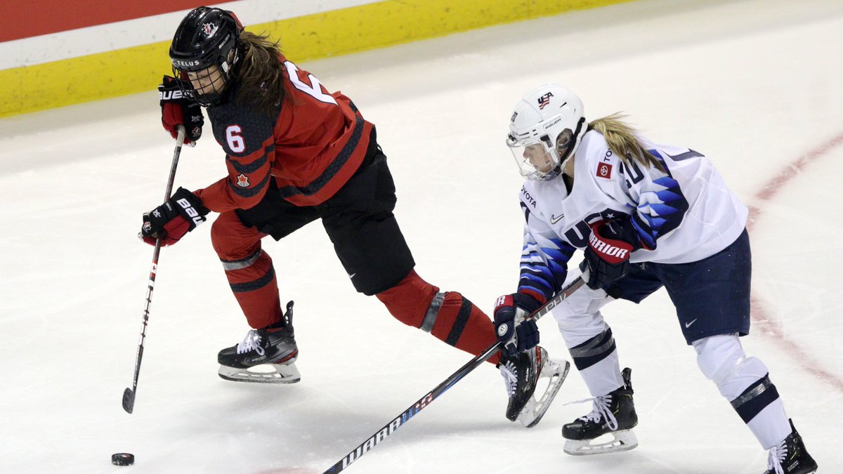 Rebecca Johnston moves the puck with against a US player.
