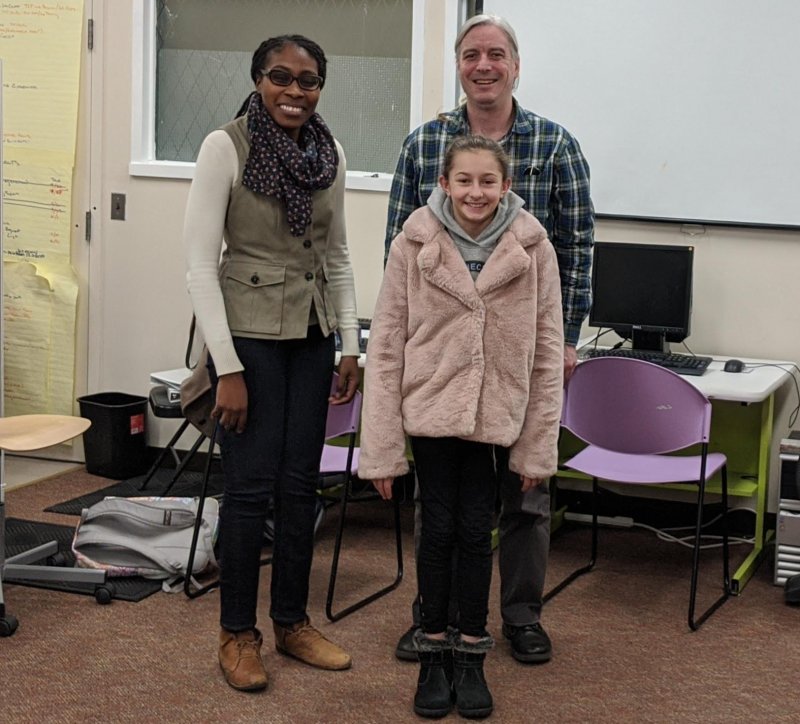 three attendees standing at event