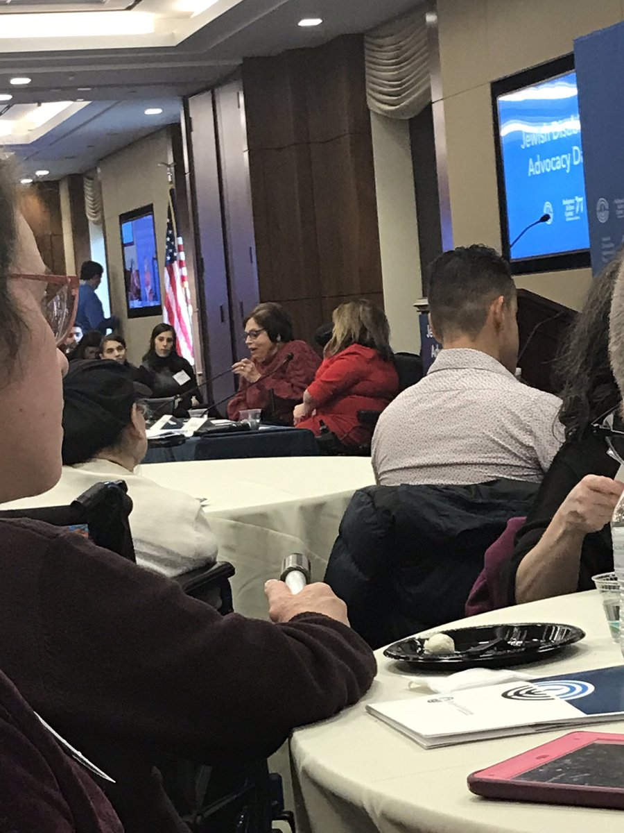 Judy speaking at the front of room