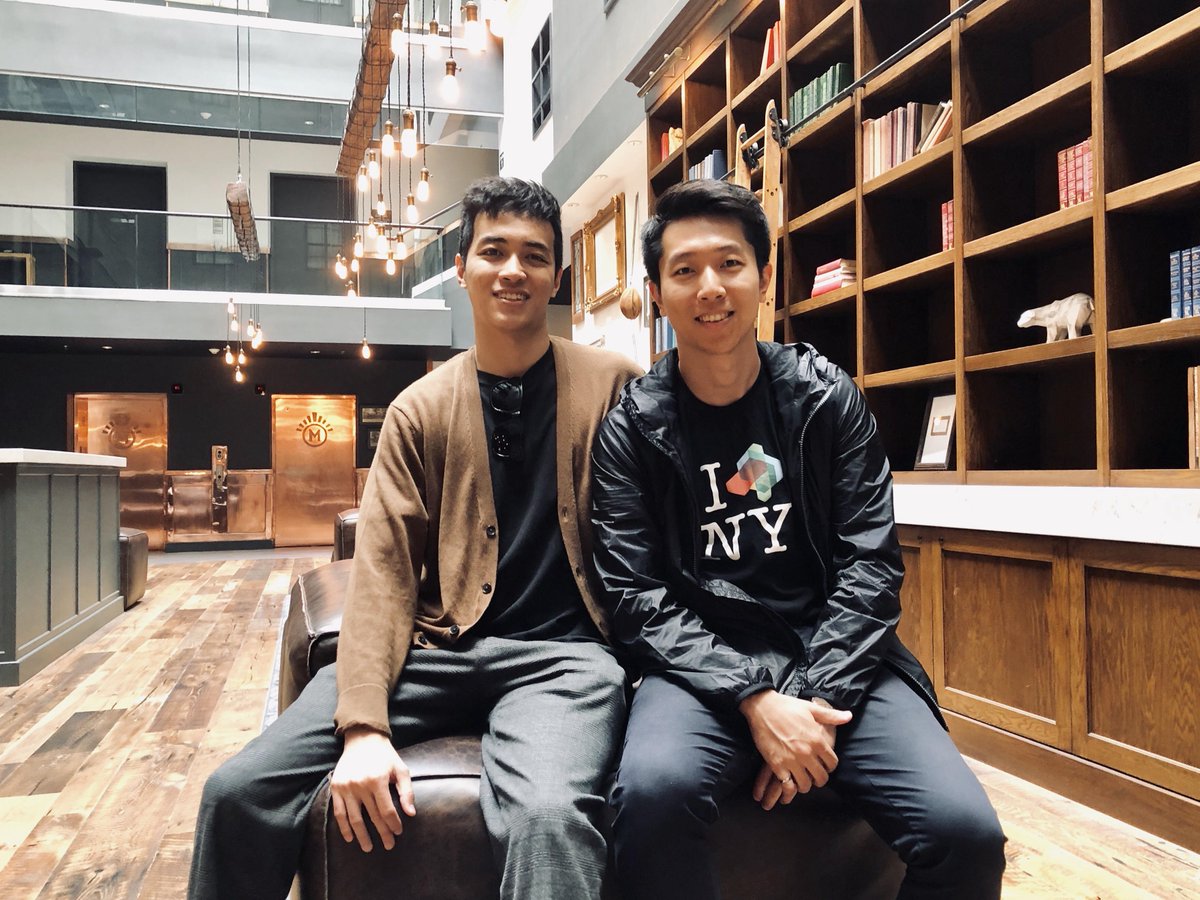 2 men sitting on couch