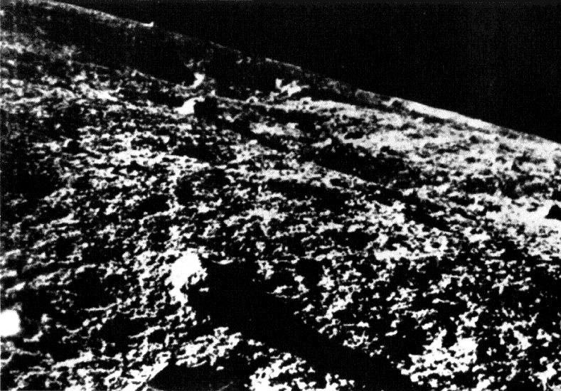 Black and white photo of lunar surface. 