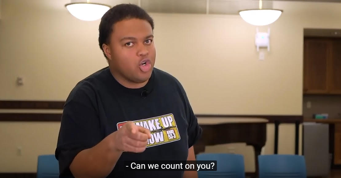 African American man points at the camera in a video still with the visible caption, "Can we count on you?"