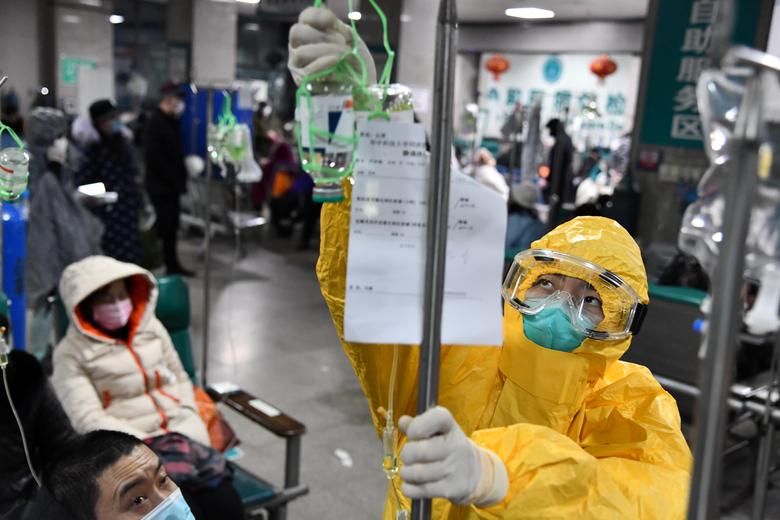 escondidos's tweet photo. A medical worker in protective suit adjusts a drip bag for a patient at a hospital, following an outbreak of the new #coronavirus in #Wuhan, Hubei province, #China, February 3. https://t.co/9KSsA1z9bG