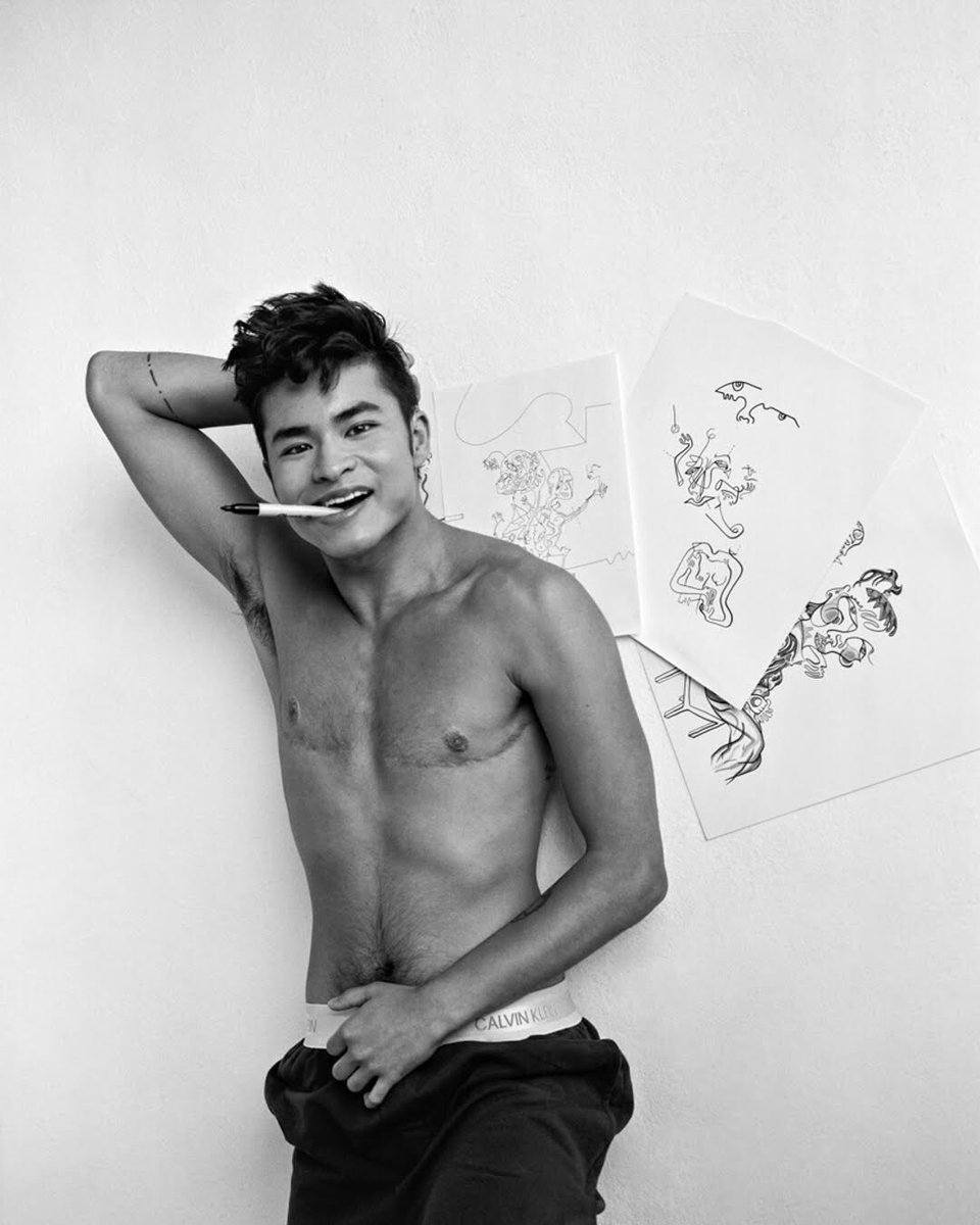 Chella laying with his art