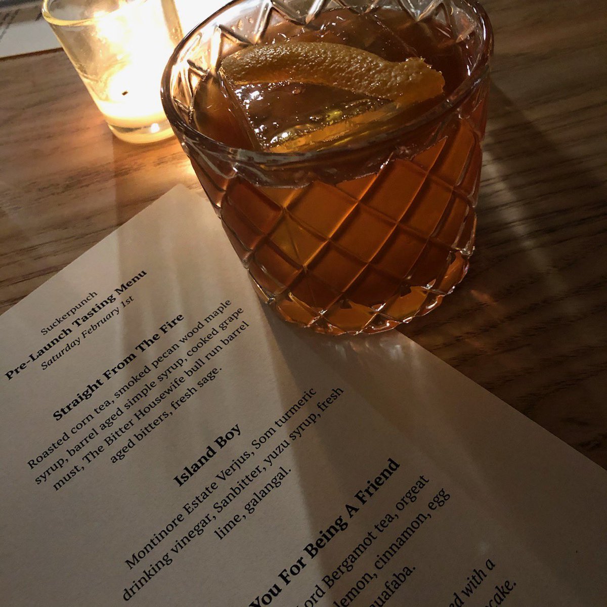 Photo of Suckerpunch menu and cocktail glass