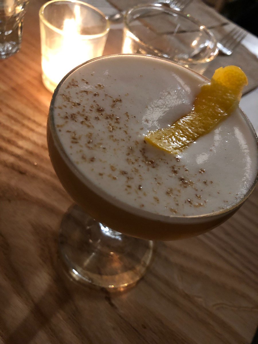 Photo of cocktail with aquafaba foam and orange garnish