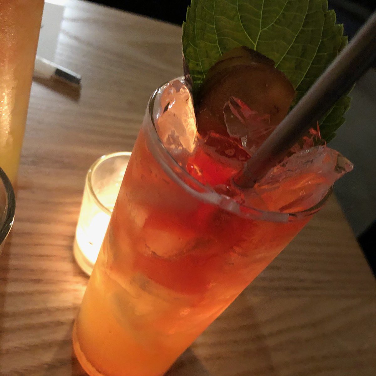 Photo of cocktail in tall glass with garnish