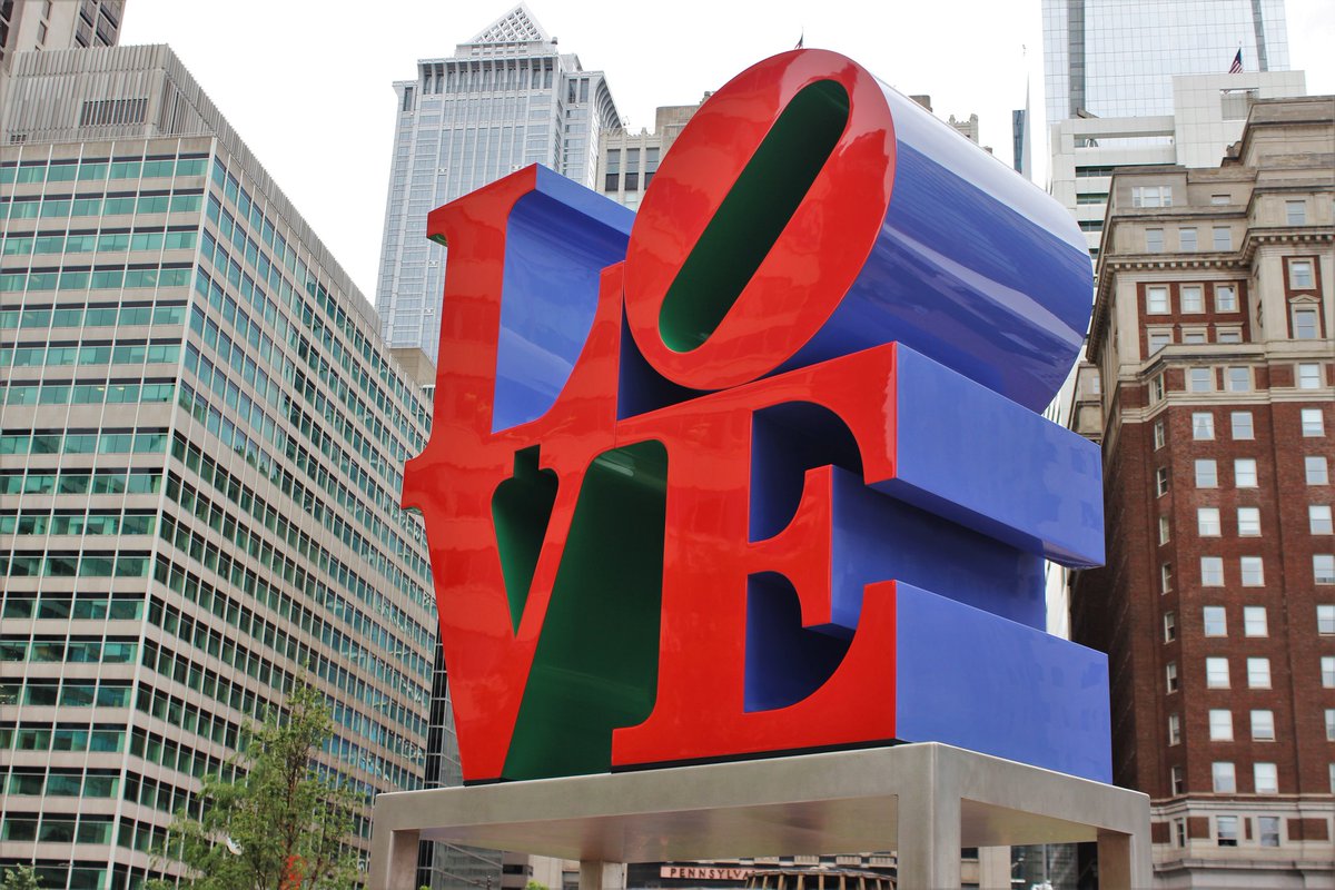 the love sculpture with sky scrappers in the background