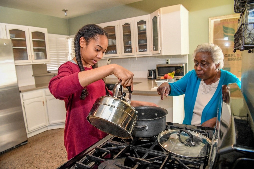 grandmother and granddaughter cooking 