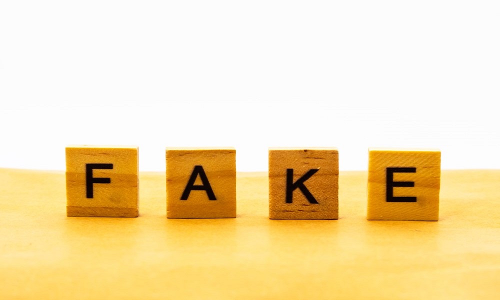 Tiles spelling the word Fake