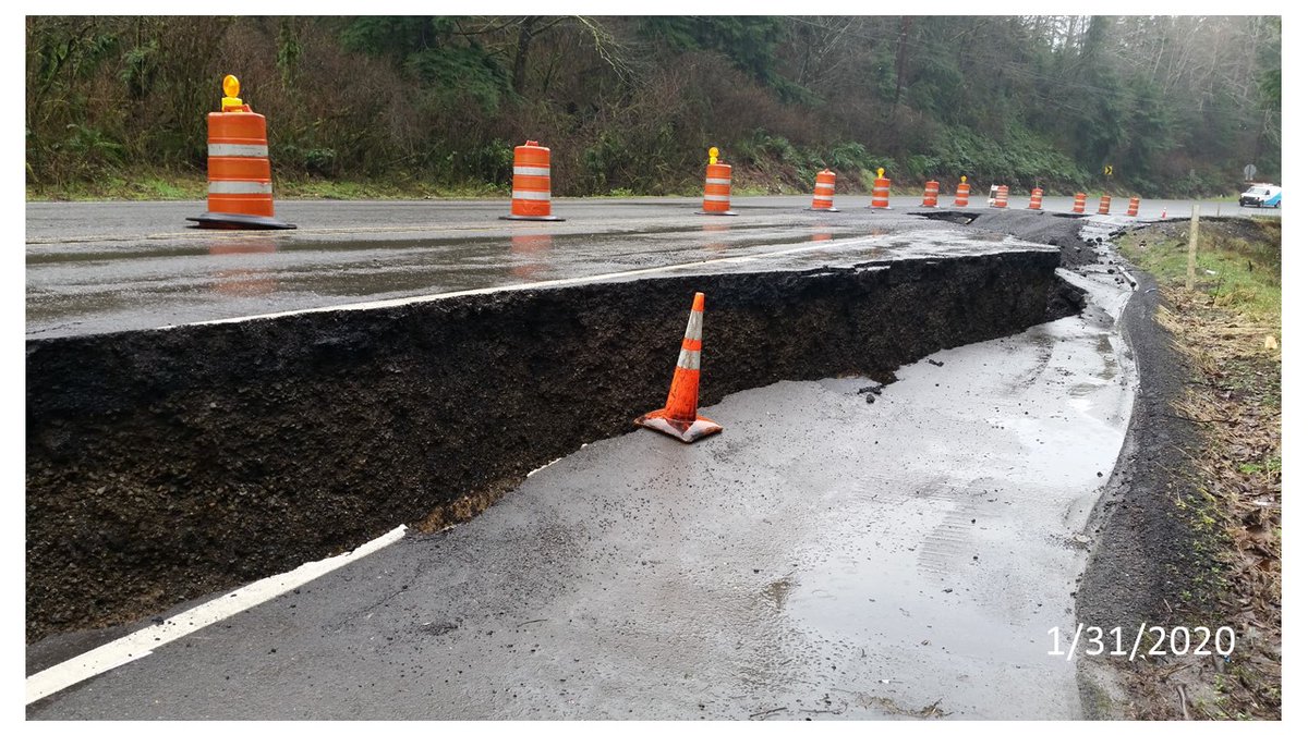 Traffic cone next to a crack in pavement. The crack is deeper than the cone is tall (1/31/2020)