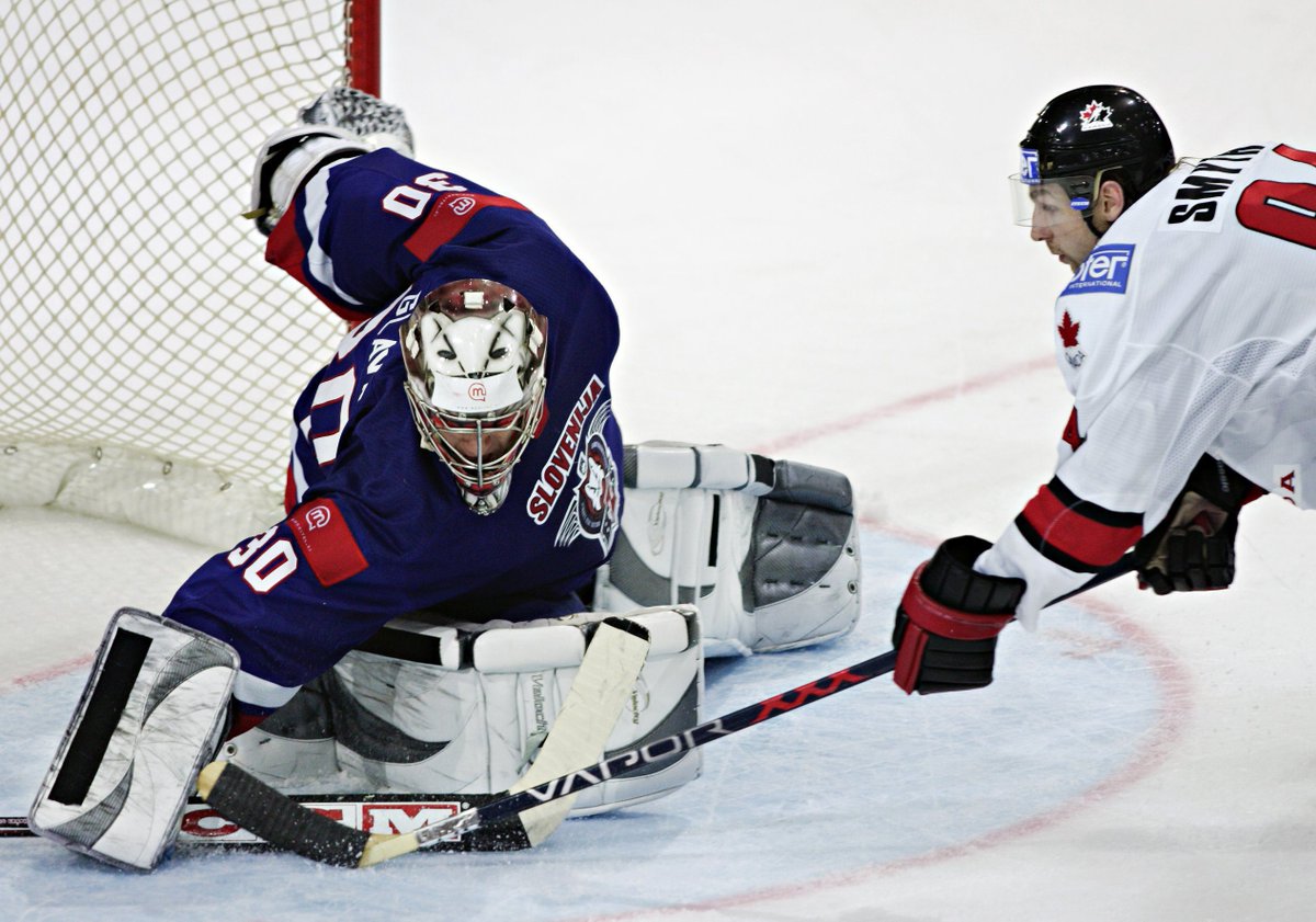 Ryan Smyth lunges in to score on Team Slovenia goaltender Gaber Glavic.