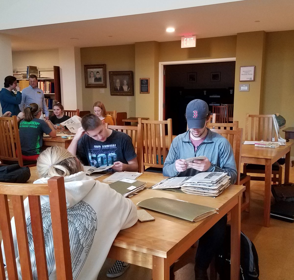 Students look at newspaper clippings files at the tables in the Cratis Williams Reading Room.