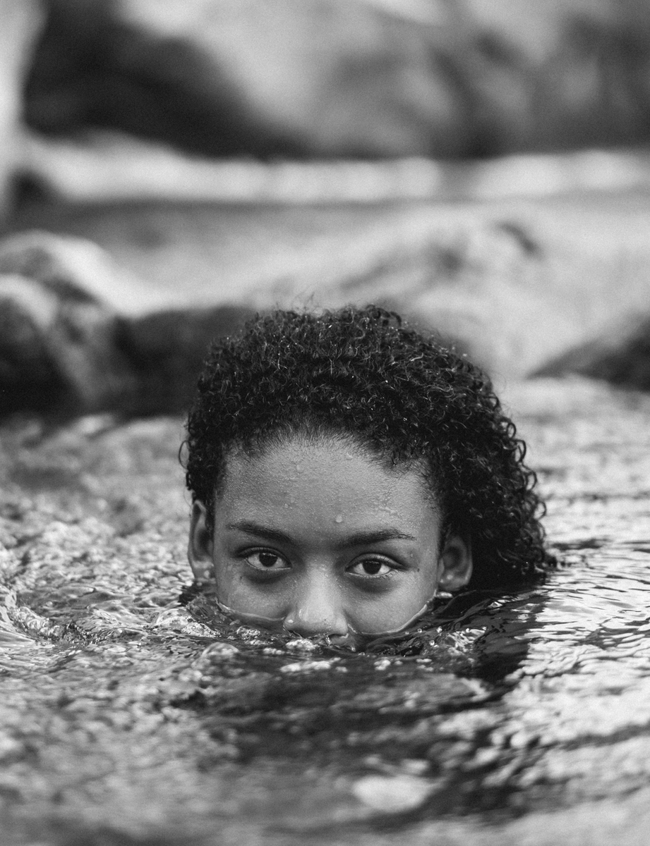 Girl swimming, with only the upper part of her head visible
