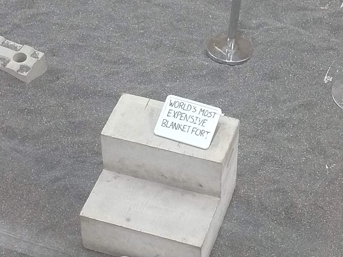 A whiteboard inside the testing room that's visible to tours above. It reads "World's most expensive blanket fort."