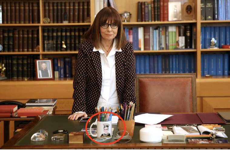 GreekAnalyst's tweet photo. Katerina Sakellaropoulou, a top jurist who was just elected as #Greece's first female President, has a "Notorious RBG" mug in her office — a wordplay of the greatest rapper of all time, and an ode to the women's rights icon and U.S. Supreme Court Justice Ruth Bader Ginsburg. ⚖️✌️ https://t.co/dNNPnCQrYY