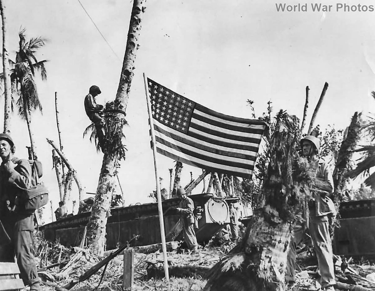 American Flag flies over Guam beachhead as troops move inland