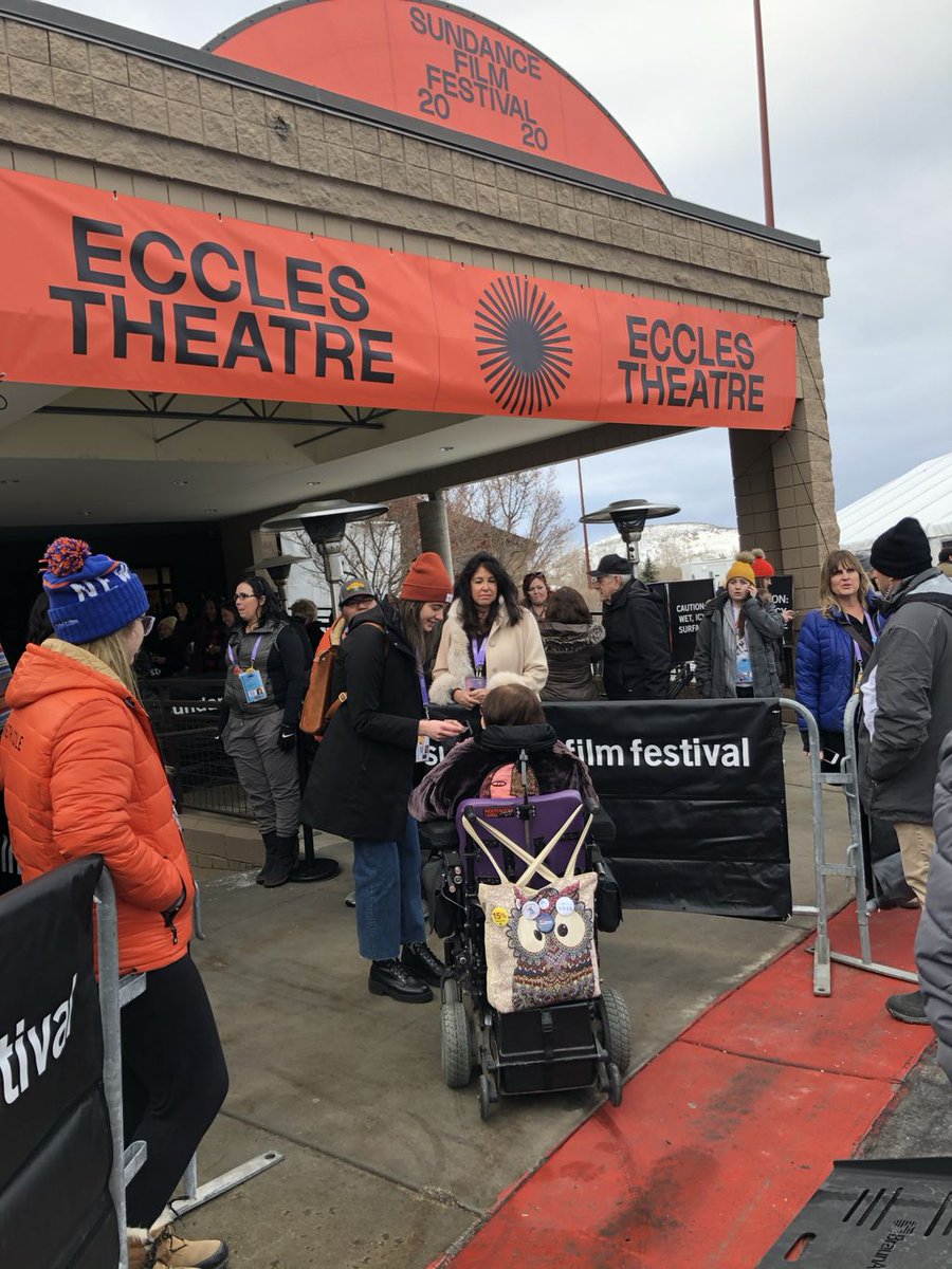 Judy being greeted at Sundance under a large orange arch way saying: Sundance Film Festival 2020 Eccles Theatre
