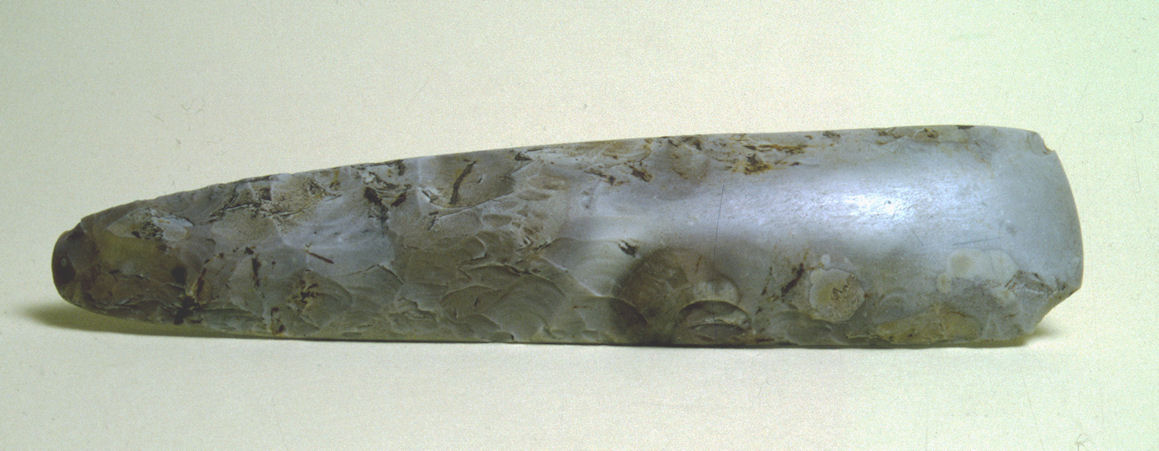 Knapped grey flint axe head with polish at cutting edge end