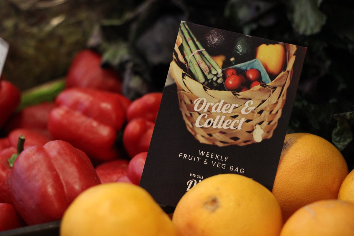 A Dig In leaflet sits upright among some colourful fruit and veg