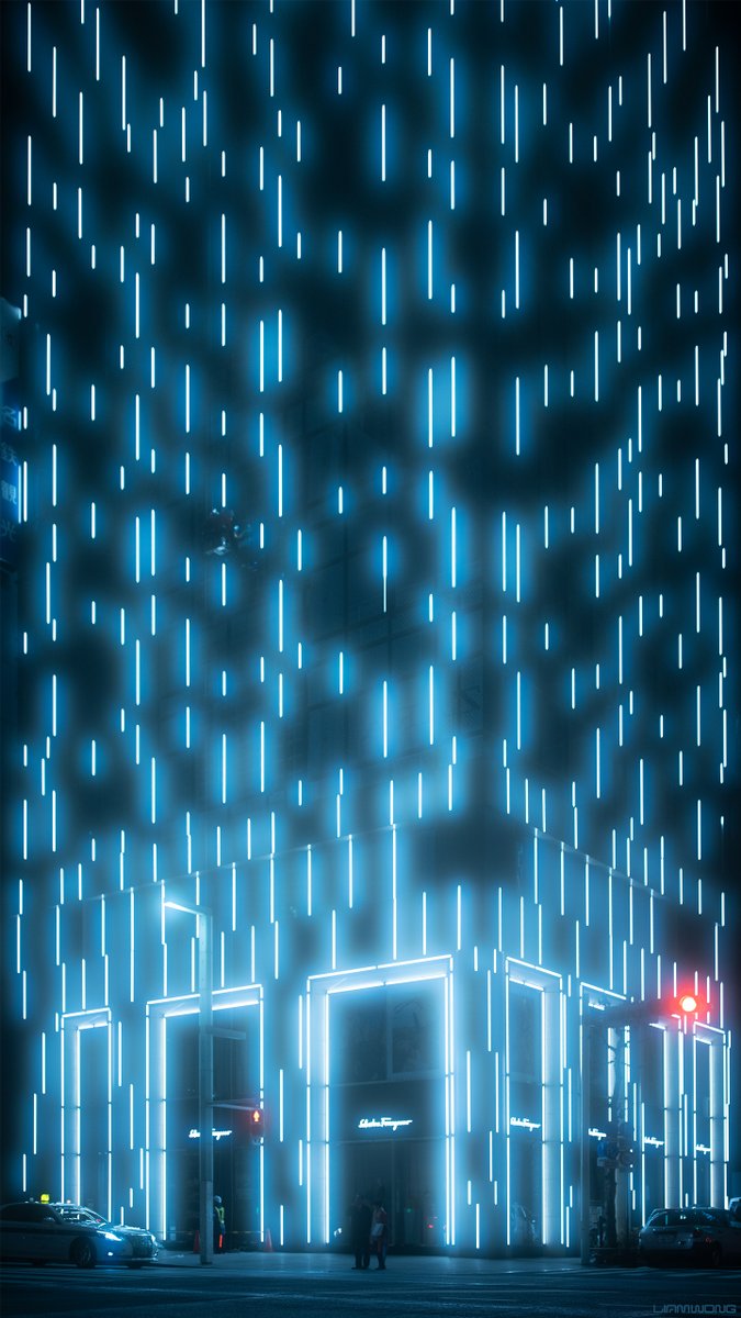 Photography by Liam Wong of Tokyo at night in the Ginza district. A large building in the upper market area of Tokyo: many bright strips of light cover the front of a modern building - it looks like rain in neon form. A couple stand at the bottom of the frame in silhouettes. They are miniscule in the 9:16 format image. There is a glow to the lights from the filter. It is a light blue in color, almost sterile.