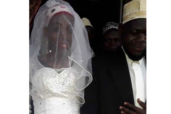 ....in court for love. Ugandan muslim cleric and bride(right) further remanded to Ntenjeru prison  till Jan30th on homosexuality charges.