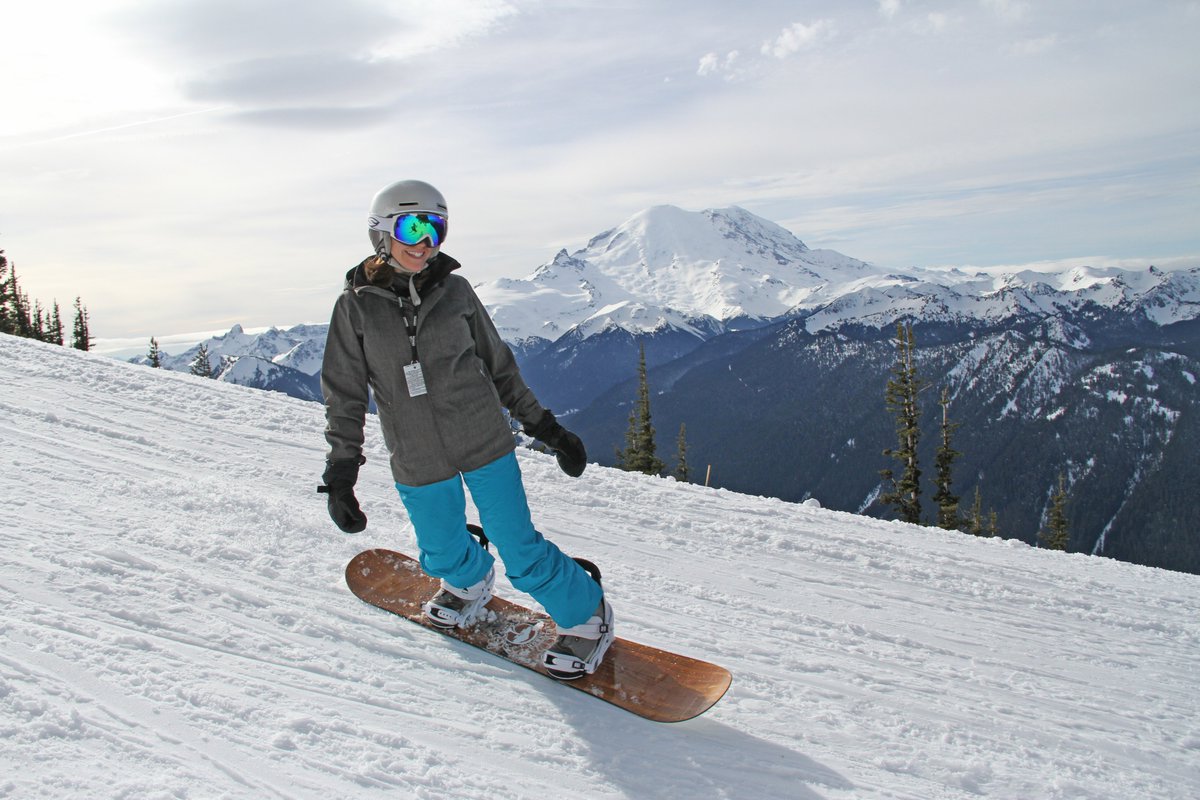 Snowboarder at Crystal Mountain Resort with Mount Rainier in the background