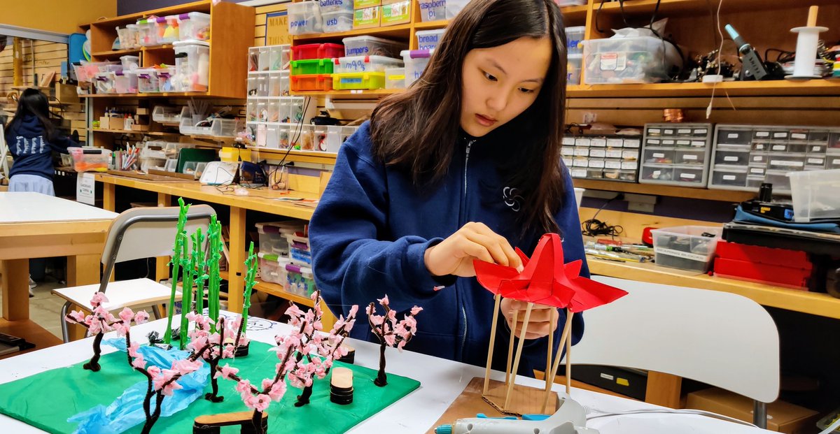 Mandarin student is constructing a park as part of a unit on city structures. She'll explain her creation in Mandarin on a presentation.
