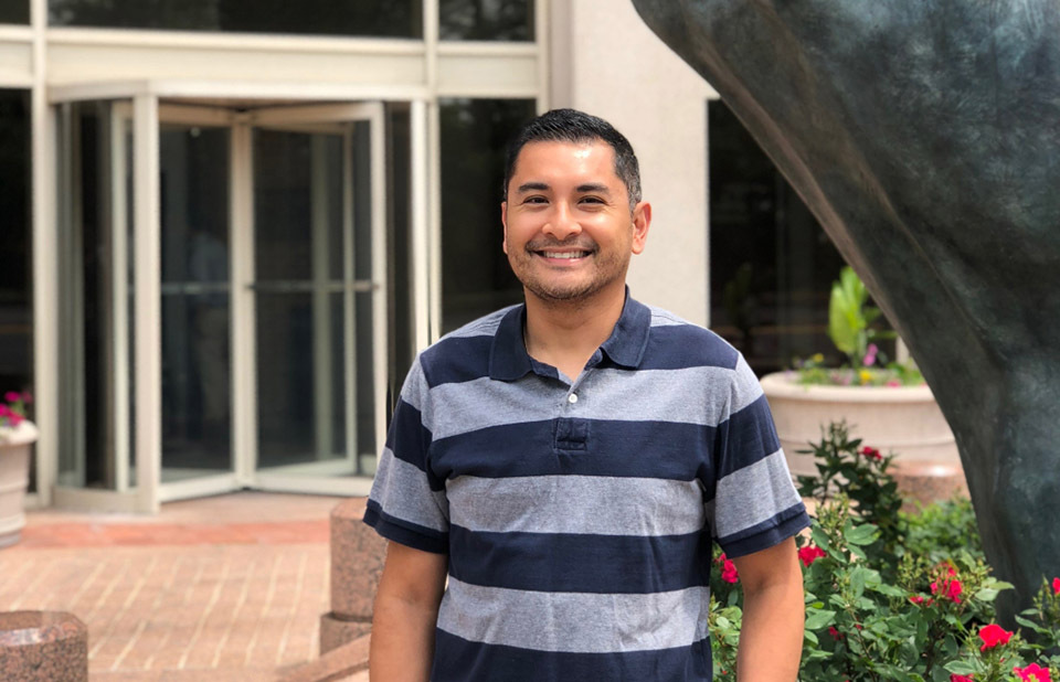 Image of Brian Martinez standing in front of the NOAA building in Silver Spring, Maryland.