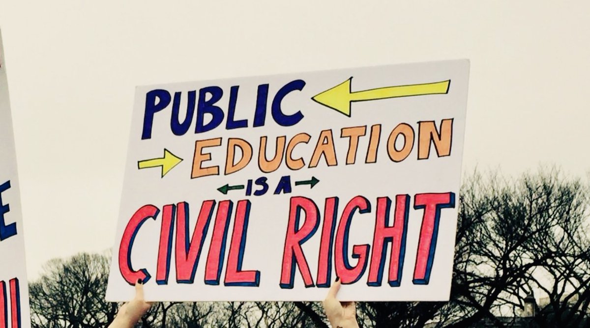 A protest sign reads "Public education is a civil right."