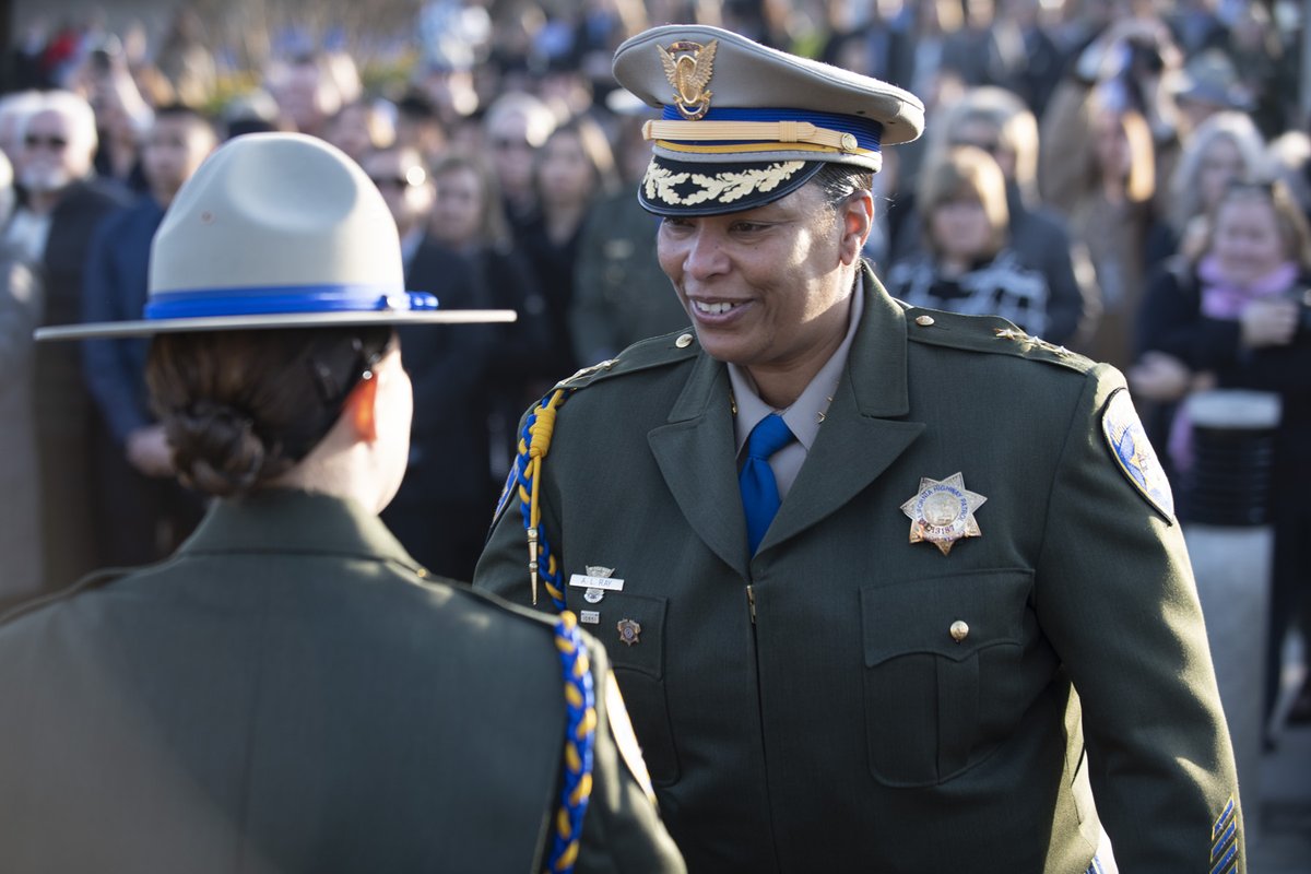 Assistant Commissioner Amanda Ray congratulates the soon-to-be new officers prior to graduation.