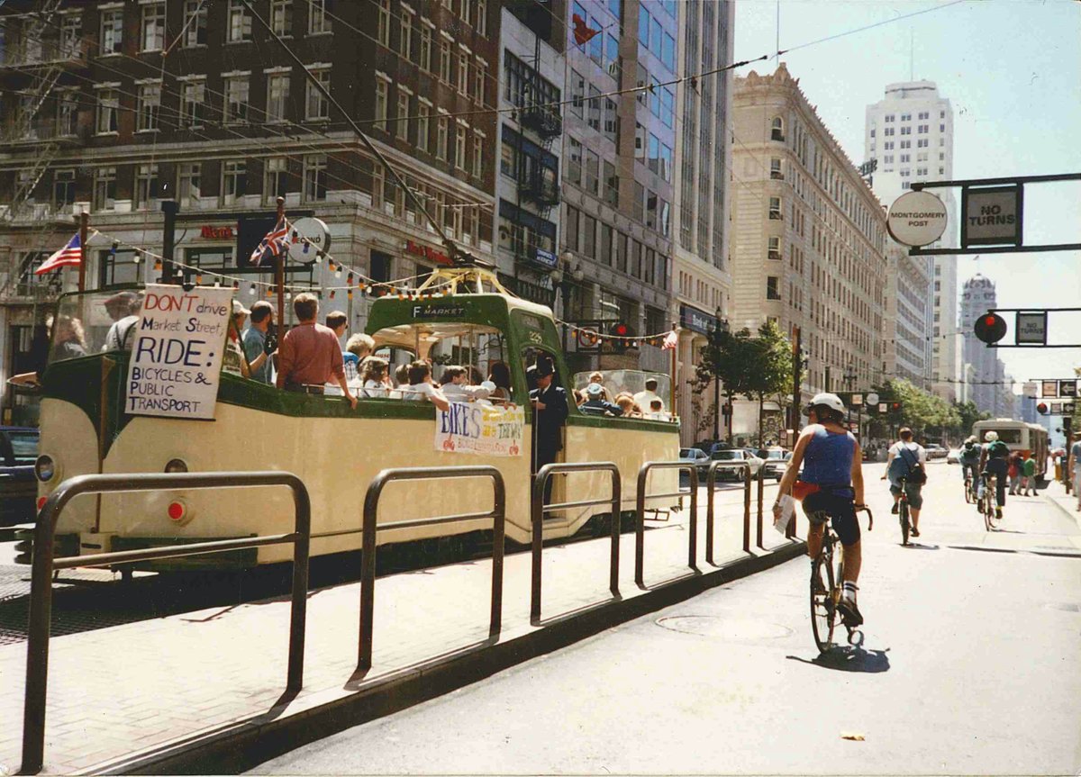 special boat tram carrying activists holding signs demanding car-free Market Street