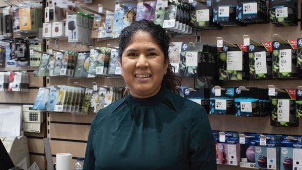 Marlene Harrilal standing behind the counter in the shop