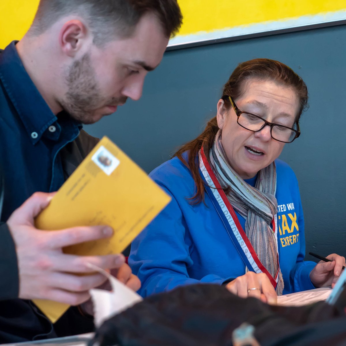 Tax help volunteer helping someone.
