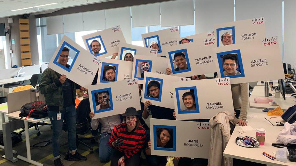 A group of employees holding a ctu-out cardboard of their employee tag