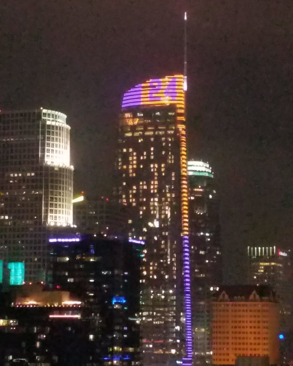 ABC7's tweet photo. The Wilshire Grand tower in Downtown Los Angeles is illuminated in purple and gold with "24" on top in honor of #kobebryant. https://t.co/UKooHxnFOy